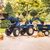 Traktors ar pedāļiem, piekabi un lāpstu zils
